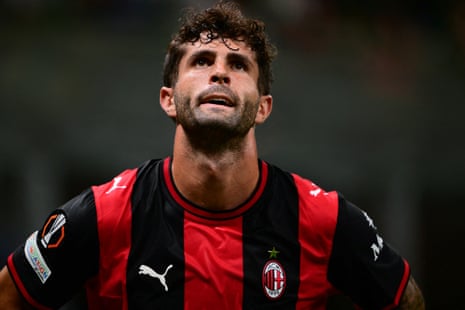 Christian Pulisic looks upward during a match, wearing a Milan jersey