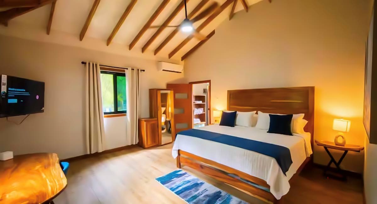 The cottage’s serene bedroom offers a restful retreat, with natural surroundings adding to the sense of tranquillity.